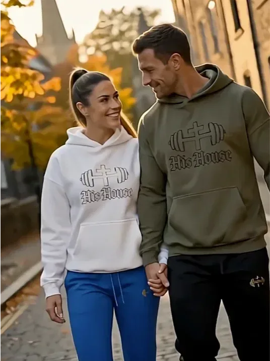 Couple wearing matching His House hoodies outdoors