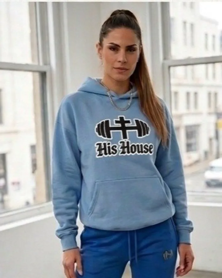 Woman wearing the His House Heritage Outline hoodie in Carolina Blue